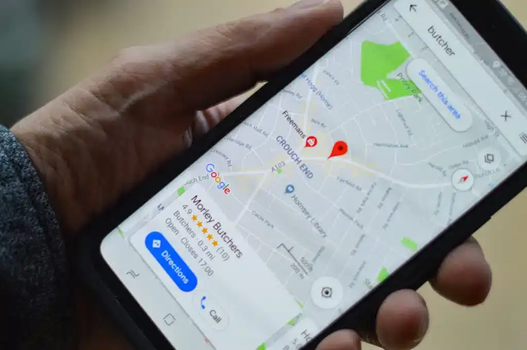 A smartphone closeup showing the local results from a search query.